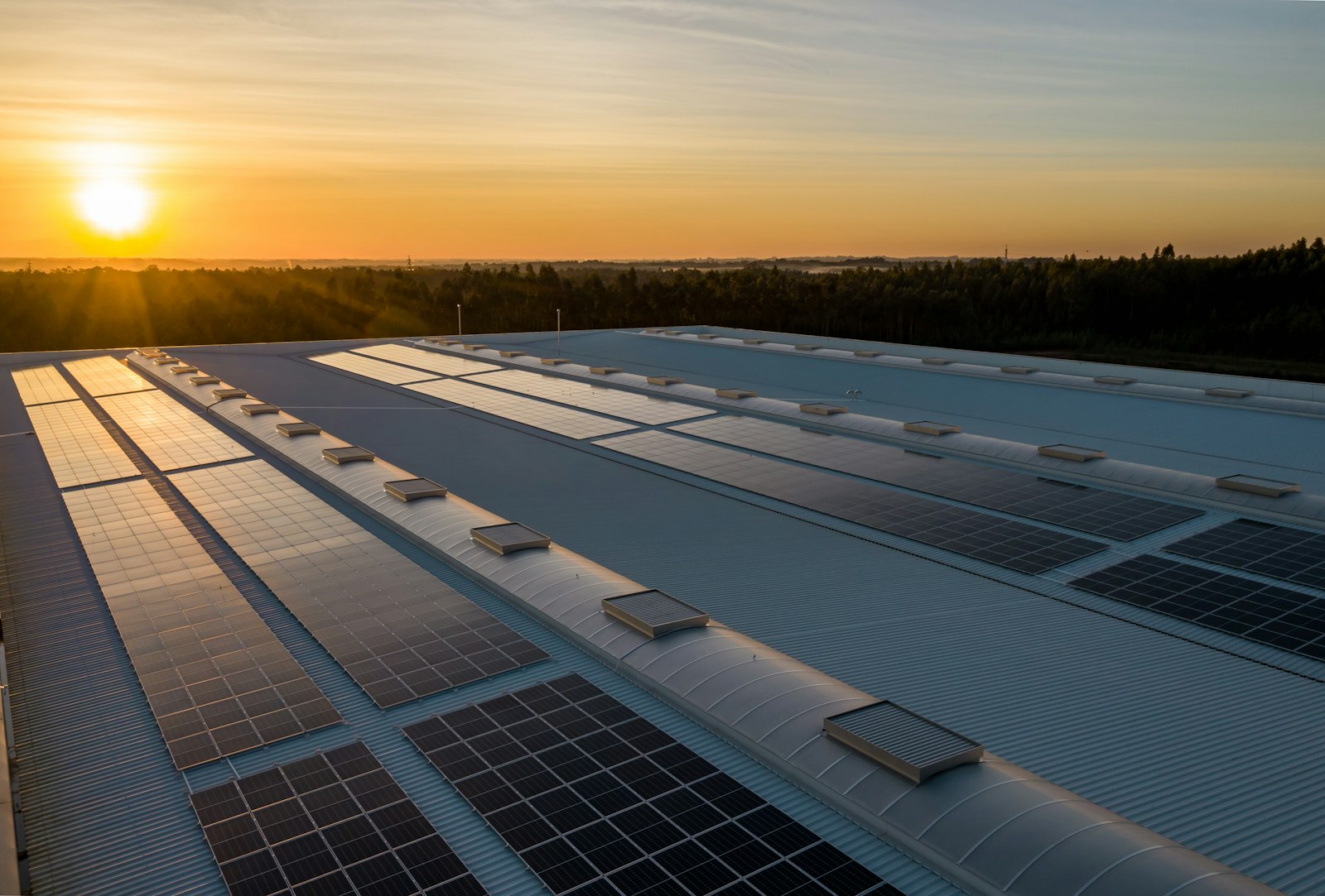 Industrial rooftop solar plant at sunrise